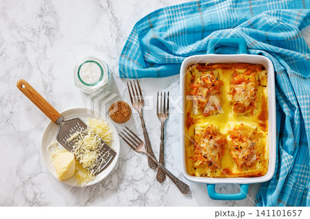 Cheesy Veggie Baked White Fish in blue baking dish Cheesy Veggie Baked White Fish in blue baking dish 141101657