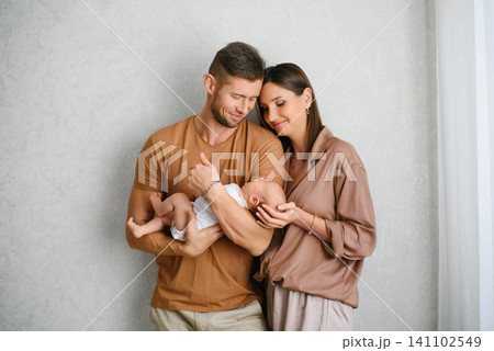 Parents Admiring Their Newborn Baby At Home Parents Admiring Their Newborn Baby At Home 141102549