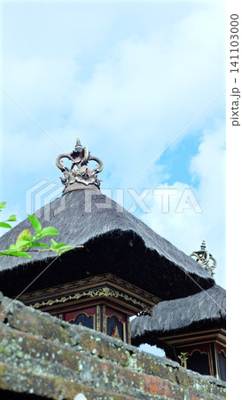 Balinese house temple shrines with black thatch roofs against blue sky. Bali style Balinese house temple shrines with black thatch roofs against blue sky. Bali style 141103000