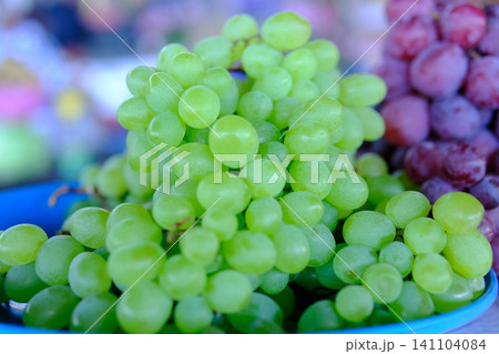 green and blue grapes. Fresh green and purple grapes displayed at local market healthy seasonal fruit and natural food 141104084