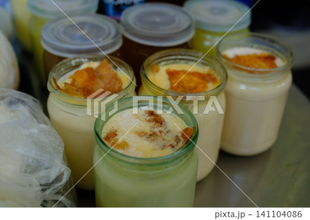 homemade fermented baked milk in half-liter jars on the market. Homemade fermented dairy beverage rich in probiotics featuring kefir buttermilk and yogurt homemade fermented baked milk in half-liter jars on the market. Homemade fermented dairy beverage rich in probiotics featuring kefir buttermilk and yogurt 141104086