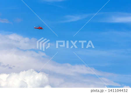 red medical rescue helicopter flying high in the blue sky, copy space 141104432