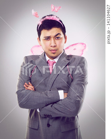 Studio, portrait and man as fairy for magic in Halloween party of startup up business and company. Adult, guy and male person with professional suit, costume and frown on face with arms crossed Studio, portrait and man as fairy for magic in Halloween party of startup up business and company. Adult, guy and male person with professional suit, costume and frown on face with arms crossed 141104627