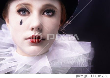 Face, woman and magician performer in studio on black background with creative makeup for entertainment, artist and passion. Portrait, female person and outfit to perform tricks or jokes at circus Face, woman and magician performer in studio on black background with creative makeup for entertainment, artist and passion. Portrait, female person and outfit to perform tricks or jokes at circus 141104709