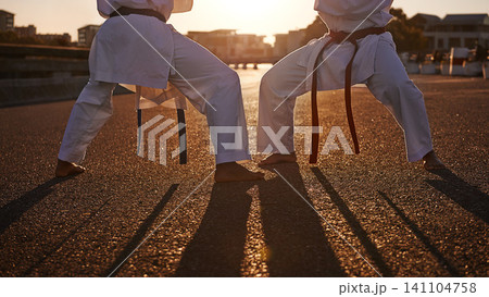 People, karate and legs with martial arts in self defense, class or teaching in the city street. Outdoor fighter, athlete or sparring partner in fitness training, kata or technique in an urban town People, karate and legs with martial arts in self defense, class or teaching in the city street. Outdoor fighter, athlete or sparring partner in fitness training, kata or technique in an urban town 141104758