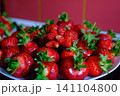 Bright fresh strawberries arranged on white plate creating colorful summer fruit presentation for healthy breakfast dessert and natural organic food close up photography 141104800