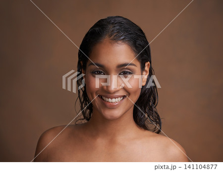 Hair, wet or portrait of happy woman in studio for beauty, wellness or shine cosmetics on brown background. Haircare, cleaning or face of Indian female model smile for shampoo, results or scalp detox Hair, wet or portrait of happy woman in studio for beauty, wellness or shine cosmetics on brown background. Haircare, cleaning or face of Indian female model smile for shampoo, results or scalp detox 141104877