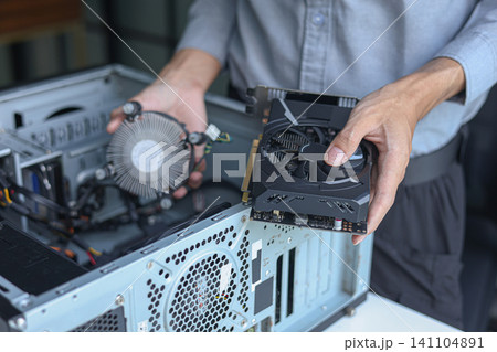 Close up of electronic technician hands working on computer repair. Close up of electronic technician hands working on computer repair. 141104891