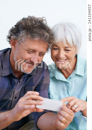 Smile, cellphone and mature couple networking internet, mobile app or website together for bonding. Happy, love and senior man and woman reading online blog for information with phone for marriage. Smile, cellphone and mature couple networking internet, mobile app or website together for bonding. Happy, love and senior man and woman reading online blog for information with phone for marriage. 141104957