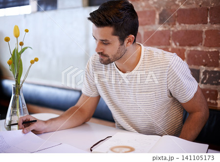 Young man, paperwork and coffee shop with documents for planning, reading or finance at indoor restaurant. Male person or freelancer checking financial budget, journal or planner in notebook at cafe Young man, paperwork and coffee shop with documents for planning, reading or finance at indoor restaurant. Male person or freelancer checking financial budget, journal or planner in notebook at cafe 141105173