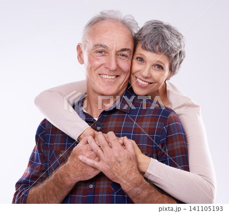 Love, hug and portrait of senior couple on a white background for bonding, affection and loving relationship. Marriage, happy and mature man and woman embrace for commitment, trust and care in studio 141105193