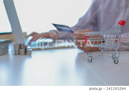 Businessman secure online payment using a credit card and a laptop, concept for online shopping and payment. Businessman secure online payment using a credit card and a laptop, concept for online shopping and payment. 141105264