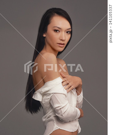 Portrait, shirt and beauty with woman, fashion and confident girl on a grey studio background. Face, person and model with stylish lingerie and mockup space with pride, aesthetic and casual outfit Portrait, shirt and beauty with woman, fashion and confident girl on a grey studio background. Face, person and model with stylish lingerie and mockup space with pride, aesthetic and casual outfit 141105337