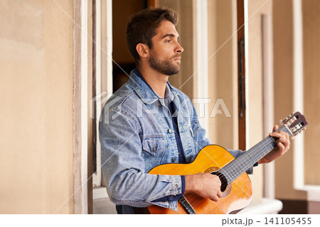 Guitar, music and instrument for thoughtful male person, outside on patio or veranda. Acoustic, singer and talent for man musician for entertainment, enjoyment and pensive on holiday or vacation Guitar, music and instrument for thoughtful male person, outside on patio or veranda. Acoustic, singer and talent for man musician for entertainment, enjoyment and pensive on holiday or vacation 141105455