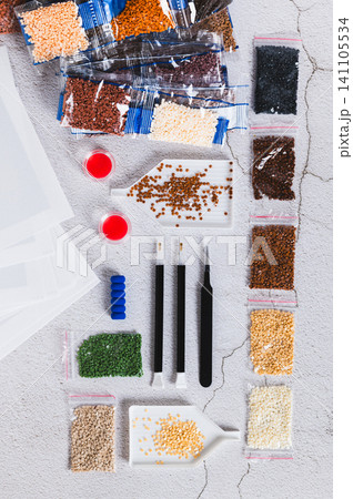 A set for handmade home crafts of colored diamond mosaic on a table top and vertical view A set for handmade home crafts of colored diamond mosaic on a table top and vertical view 141105534
