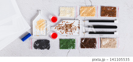 A set for handmade home crafts of colored diamond mosaic on a table top view web banner A set for handmade home crafts of colored diamond mosaic on a table top view web banner 141105535