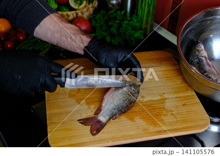 full recipe Complete process of cooking crispy fried crucian carp from cleaning and seasoning to golden frying in nonstick pan creating traditional homemade fish recipe close up food video 141105576