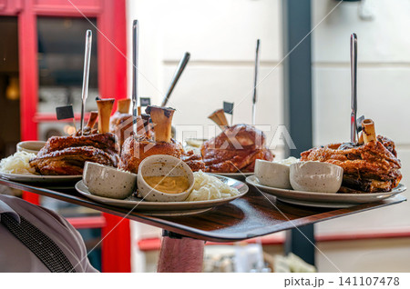 Food served at a restaurant in Prague with plates of meat and side dishes Food served at a restaurant in Prague with plates of meat and side dishes 141107478