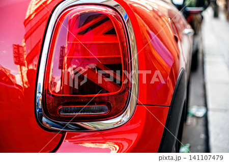 Red car tail light shows Union Jack design in Prague street during a sunny day Red car tail light shows Union Jack design in Prague street during a sunny day 141107479