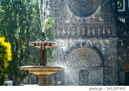Fountain in Prague with water spraying near a historic building during daytime Fountain in Prague with water spraying near a historic building during daytime 141107491