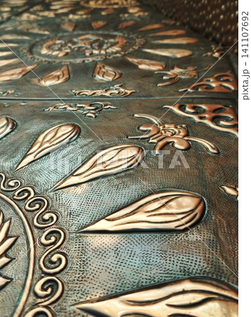 Handmade engraved copper metal texture with floral motifs. Handmade engraved copper metal texture with floral motifs. 141107692