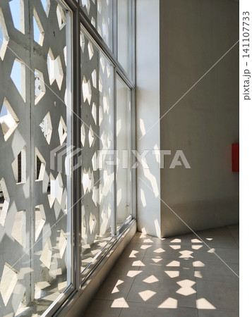 Corridor with concrete roster walls casting shadows. Corridor with concrete roster walls casting shadows. 141107733