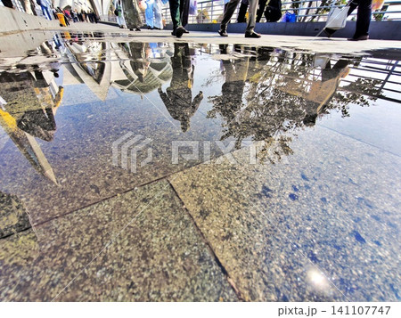 Reflection of visitors and architecture on a marble floor. Reflection of visitors and architecture on a marble floor. 141107747