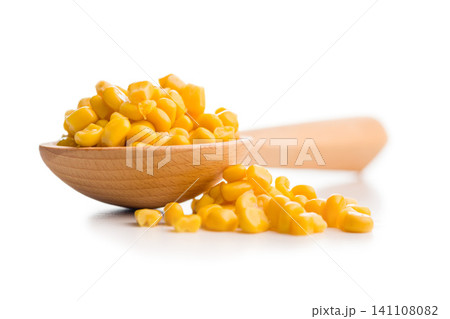 Close-Up of Yellow Corn Kernels in a Wooden Spoon on White Background Close-Up of Yellow Corn Kernels in a Wooden Spoon on White Background 141108082