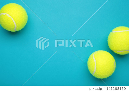 Bright yellow tennis balls on blue background. Space for text Bright yellow tennis balls on blue background. Space for text 141108150