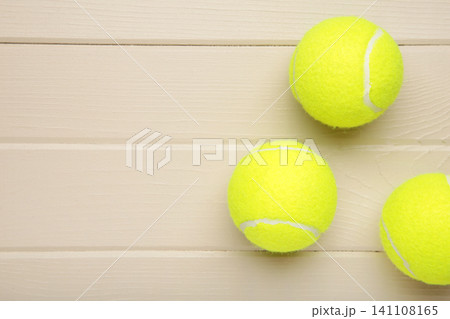 Bright yellow tennis ball on light background Bright yellow tennis ball on light background 141108165
