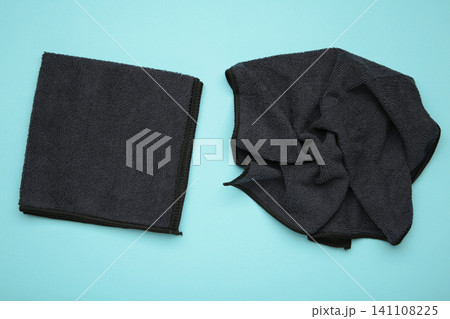Microfiber cloth for cleaning and dusting on blue background. Microfiber cloth for cleaning and dusting on blue background. 141108225