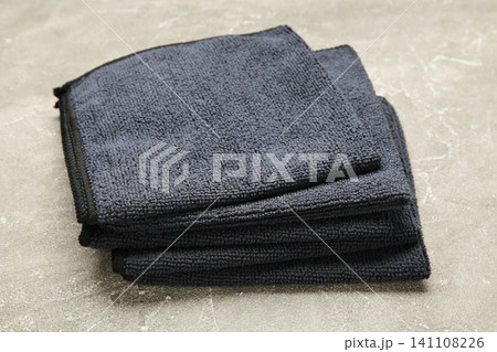 Microfiber cloth for cleaning and dusting on grey concrete background. Microfiber cloth for cleaning and dusting on grey concrete background. 141108226