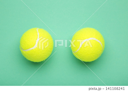 Bright yellow tennis balls on mint background 141108241