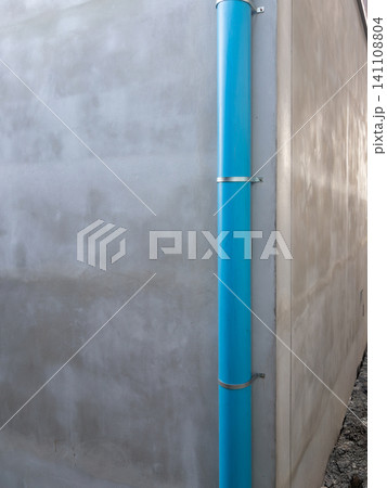 Blue PVC Downspout Pipe on Concrete Wall Blue PVC Downspout Pipe on Concrete Wall 141108804