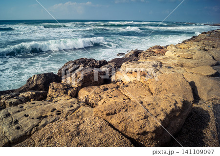Waves crashing against the rocky coastline with a view of the Mediterranean Sea in Tel Aviv Waves crashing against the rocky coastline with a view of the Mediterranean Sea in Tel Aviv 141109097