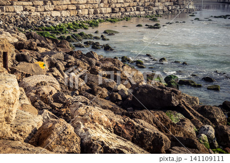 Waves crashing against the rocky coastline with a view of the Mediterranean Sea in Tel Aviv Waves crashing against the rocky coastline with a view of the Mediterranean Sea in Tel Aviv 141109111