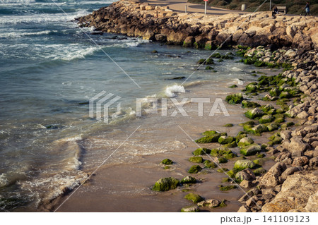 Waves crashing against the rocky coastline with a view of the Mediterranean Sea in Tel Aviv 141109123