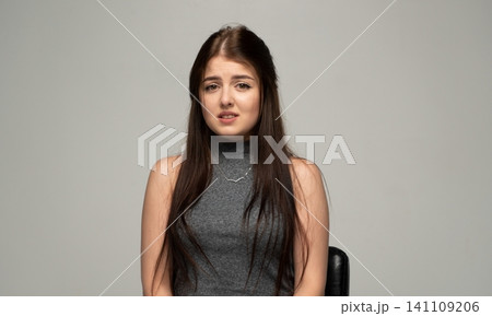 Young woman feeling anxious, showing fear and worry with a nervous facial expression. Concepts of stress, problems, and frustration Young woman feeling anxious, showing fear and worry with a nervous facial expression. Concepts of stress, problems, and frustration 141109206
