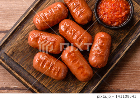 Chicken or pork grilling sausages with garlic, salt, and spices. Grilling sausages 141109343