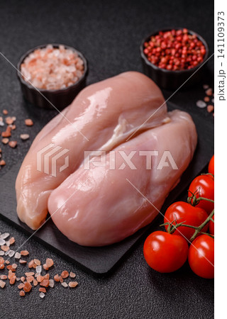 Fresh raw chicken fillet with salt and spices for home cooking. Raw chicken fillet Fresh raw chicken fillet with salt and spices for home cooking. Raw chicken fillet 141109373