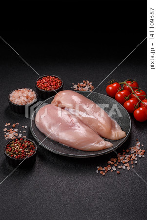 Fresh raw chicken fillet with salt and spices for home cooking. Raw chicken fillet Fresh raw chicken fillet with salt and spices for home cooking. Raw chicken fillet 141109387