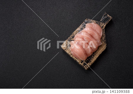 Fresh raw chicken fillet with salt and spices for home cooking. Raw chicken fillet Fresh raw chicken fillet with salt and spices for home cooking. Raw chicken fillet 141109388