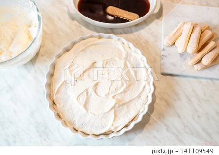 Homemade tiramisu with cream layer on marble surface top view Homemade tiramisu with cream layer on marble surface top view 141109549