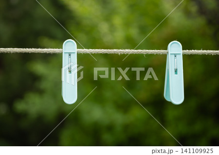 Clothespins on clothesline empty outdoor minimal background with copy space Clothespins on clothesline empty outdoor minimal background with copy space 141109925