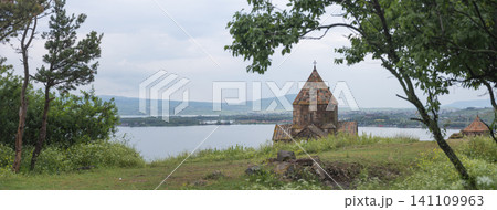 Sevanavank monastery panorama framed by green trees with copy space lake Sevan Sevanavank monastery panorama framed by green trees with copy space lake Sevan 141109963