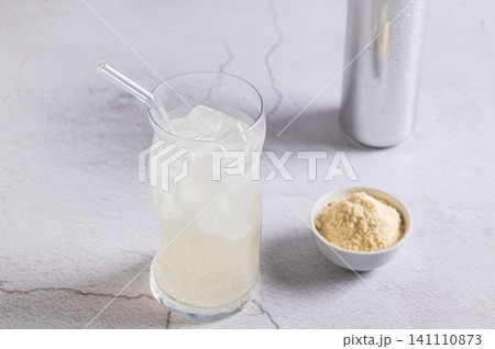 Carbonated protein drink in a glass and a can on the table Carbonated protein drink in a glass and a can on the table 141110873