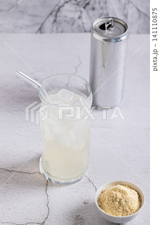 Carbonated protein drink in a glass and a can on the table vertical view Carbonated protein drink in a glass and a can on the table vertical view 141110875