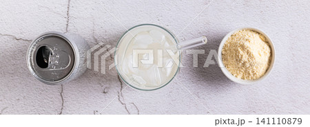 Carbonated protein drink in a glass and a can on the table top view web banner Carbonated protein drink in a glass and a can on the table top view web banner 141110879