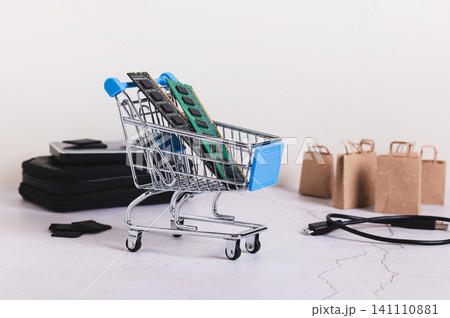 Two computer memory modules in a shopping cart on a table Two computer memory modules in a shopping cart on a table 141110881
