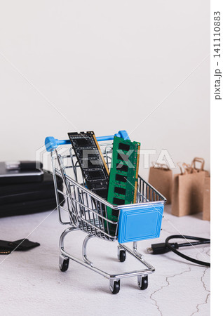 Two computer memory modules in a shopping cart on a table vertical view Two computer memory modules in a shopping cart on a table vertical view 141110883
